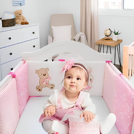 tour de lit bebe fille rose et blanc dans un lit a barreaux