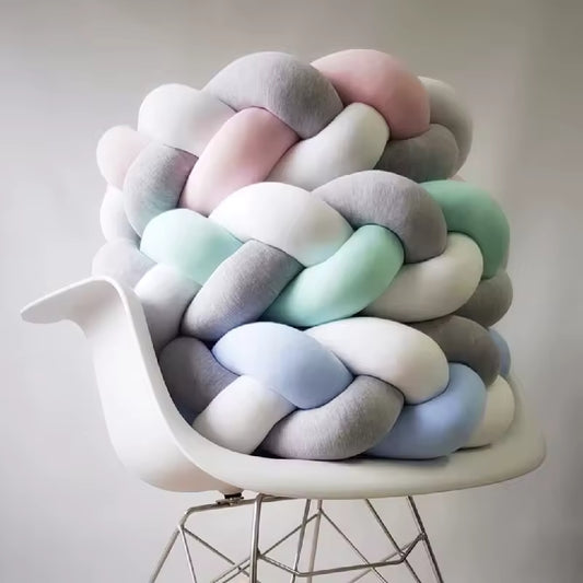 tour de lit bebe tresse grise et verte sur une chaise