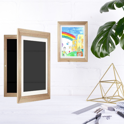 cadre dessin enfant couleur bois sur un mur et un bureau