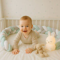 Tresse de lit bébé avec bébé qui joue en son centre